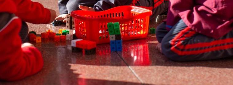 Manos de niños jugando con bloques de construcción